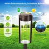 A solar garden light in a grassy outdoor setting with text overlays highlighting its features. Produktbild-Vorschau