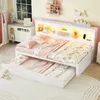 A child's bedroom with a white daybed that has a pull-out trundle bed. The room is decorated with pink and yellow accents, and there are shelves with toys and decorations. Podgląd zdjęcia produktu