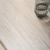 A close-up view of a table surface with a glass of water. Produktbild-Vorschau