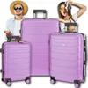 A man and a woman are posing with a set of three purple suitcases. The man is wearing a hat and sunglasses, and the woman is holding a camera. Náhled obrázku produktu