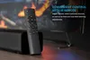 A remote control is placed in front of a soundbar with a television in the background. Podgląd zdjęcia produktu