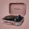 A pink suitcase-style record player is shown with its lid open. Náhled obrázku produktu