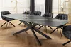A dining room scene with a large, modern dining table and chairs. Produktbild-Vorschau