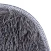 A close-up view of the edge of a fluffy gray bath mat, showing the texture of the fibers and the decorative border. Náhled obrázku produktu