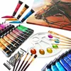 A collection of art supplies including acrylic paint tubes, a palette, and paintbrushes, arranged on a white background with a painting of a horse in the background. Náhled obrázku produktu