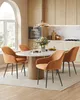 A dining set with four chairs around a round table in a modern kitchen. Produktbild-Vorschau