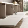 A close-up view of a white TV cabinet with its doors open, revealing internal compartments and hydraulic supports. The cabinet is placed on a wooden floor, with a window and curtains visible in the background. Náhled obrázku produktu