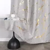 A close-up of a gray curtain with a gold marble pattern, draped over a small table with a book and a cup. Produktbild-Vorschau