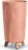 A tall, cylindrical planter with a marbled terracotta-like finish and three wooden legs. Náhled obrázku produktu