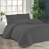 A bed with dark gray bedding is shown in a room with a window and a plant. Produktbild-Vorschau