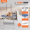 A golden retriever dog is lying on a blue grooming table in a bathroom setting. Anteprima dell’immagine prodotto
