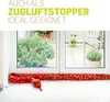 A plush snake-shaped draft stopper placed on a windowsill in front of a window overlooking a patio with plants. Produktbild-Vorschau