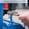 A close-up shot of a person connecting a hose to an air compressor. Produktbild-Vorschau