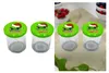 Two jars with green lids featuring a cartoon character wearing a Santa hat and text, placed on a white background on the left and on a textured fabric background on the right. Produktbild-Vorschau