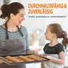 A mother and daughter are in a kitchen, holding a baking sheet with cookies. Produktbild-Vorschau