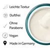 A close-up of a cream product in a teal-rimmed container, with text and icons listing product features on the left. Podgląd zdjęcia produktu