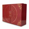 A red and gold advent calendar with floral patterns and a circular design on the front. Produktbild-Vorschau