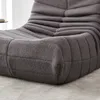 Close-up view of a gray, textured sofa. Náhled obrázku produktu