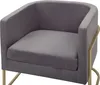 A close-up studio shot of a gray velvet armchair with gold metal legs. Náhled obrázku produktu
