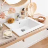 A bathroom sink area with various accessories. Anteprima dell’immagine prodotto