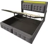 A grey upholstered bed frame with the storage compartment open and the mattress support raised, showing the internal storage space. The headboard has tufted panels and a yellow LED light strip. Náhľad obrázku produktu