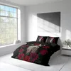 A bedroom scene with a bed dressed in a duvet cover featuring a sugar skull and rose design, next to a large window. Produktbild-Vorschau