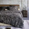 A bedroom scene with a bed dressed in paisley patterned bedding. Produktbild-Vorschau