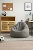 A bean bag chair and a soccer ball are placed on a rug in a room with a wooden cabinet and a desk. Voir les images du produit