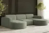 A modern living room with a large, U-shaped sectional sofa in a light green corduroy fabric.