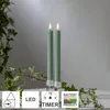 Two green LED candles with flickering flames stand in clear candle holders, surrounded by ivy branches. Produktbild-Vorschau