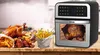 A product shot of an air fryer next to a spread of fried chicken and fries. Produktbild-Vorschau