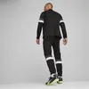 A man wearing a black Puma tracksuit, viewed from the back. Podgląd zdjęcia produktu