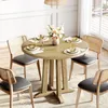 A round dining table set with place settings and a floral arrangement, surrounded by chairs in a dining room. Produktbild-Vorschau