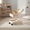 A wooden toy shopping cart and play store counter are set up in a child's room. Produktbild-Vorschau