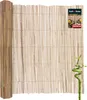 A rolled-up bamboo privacy screen is shown, with a small bamboo plant in the foreground. Podgląd zdjęcia produktu