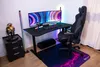 A gaming setup with a desk, chair, and monitors. Voir les images du produit