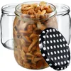 Three glass jars, one filled with mushrooms, and a polka-dot lid are arranged on a white background. Voir les images du produit