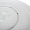 Close-up view of the underside of a white rotating cake stand, showing the circular track with screws. Anteprima dell’immagine prodotto