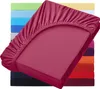 A stack of colorful fitted sheets, with one maroon sheet prominently displayed in the foreground. Produktbild-Vorschau