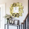 A decorative wall clock with Roman numerals is displayed on a wall above a console table with flowers and candles. Voir les images du produit