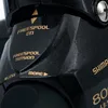 A close-up view of a black fishing reel with gold lettering indicating its features. Anteprima dell’immagine prodotto