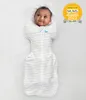 A baby is swaddled and lying on a white surface. Produktbild-Vorschau