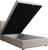 A beige upholstered bed frame with the mattress base lifted to reveal storage space underneath. Voir les images du produit