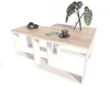 A modern coffee table with a wood top and white geometric base, styled with headphones, a smartphone, a cup of coffee, and a plant. Produktbild-Vorschau