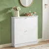 A white shoe cabinet with two drawers is shown against a green wall. Produktbild-Vorschau