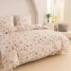 A neatly made bed with a floral and bunny patterned duvet cover and pillows in a bright room. Produktbild-Vorschau