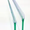 Two clear plastic shower door seals are shown attached to green glass panels, with water droplets on the seals. Podgląd zdjęcia produktu
