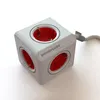 A close-up studio shot of a white PowerCube Extended power strip with red outlets. Produktbild-Vorschau