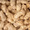 A close-up, overhead view of a pile of natural wood wool fire starters. Podgląd zdjęcia produktu