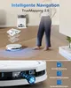 A person is standing next to a robot vacuum cleaner and its charging station, with diagrams illustrating its features. Produktbild-Vorschau